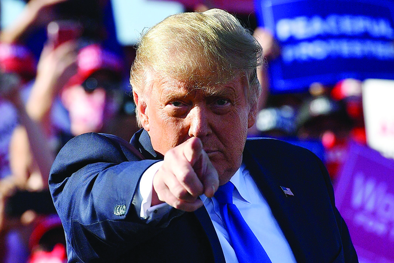 TOPSHOT - US President Donald Trump gestures as he speaks during a rally at Carson City Airport in Carson City, Nevada on October 18, 2020. (Photo by MANDEL NGAN / AFP)