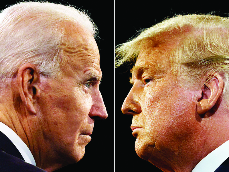 (COMBO) This combination of pictures created on October 22, 2020 shows US President Donald Trump (R) and Democratic Presidential candidate and former US Vice President Joe Biden during the final presidential debate at Belmont University in Nashville, Tennessee, on October 22, 2020. (Photos by JIM BOURG / AFP)