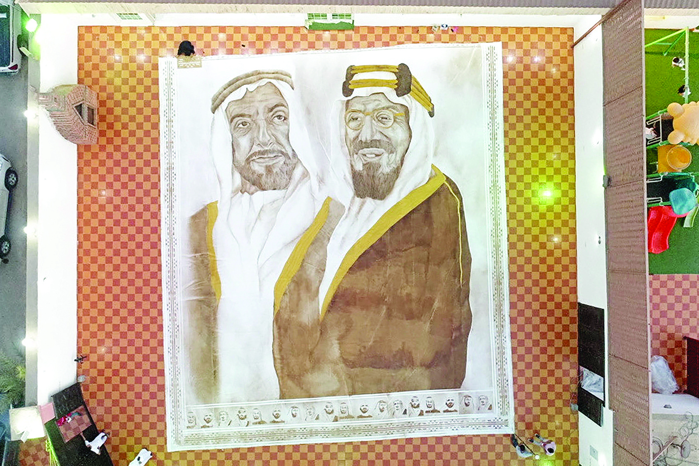 A handout picture released by the Guinness World Records on October 18, 2020 shows the world's largest coffee painting by Saudi artist Ohud Abdullah Almalki depicting founding fathers of Saudi Arabia and the UAE, the late King Abdulaziz bin Abdul Rahman (R) and the late Sheikh Zayed bin Sultan Al Nahyan, in Jeddah. - An artist from Saudi Arabia has created the world's largest coffee painting, the Guinness World Records announced today, making her the first Saudi woman to achieve a records title singlehandedly. The painting, called Naseej 1, is spread over 220 square meters in the city of Jeddah and is made out of seven connected cloths with approximately 4.5 kilogrammes of expired coffee powder. (Photo by - / Guinness World Records / AFP) / RESTRICTED TO EDITORIAL USE - MANDATORY CREDIT AFP PHOTO /GUINESS WORLD RECORDS - NO MARKETING NO ADVERTISING CAMPAIGNS -DISTRIBUTED AS A SERVICE TO CLIENTS