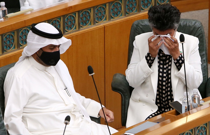 Kuwaiti Deputy Prime Minister and Minister of Interior Anas al-Saleh and MP Safaa al-Hashem mourn during a special session for late emir of Kuwait Sheikh Sabah al-Ahmad al-Sabah, at Kuwait's national assembly hall in Kuwait City on October 7, 2020. (Photo by YASSER AL-ZAYYAT / AFP)