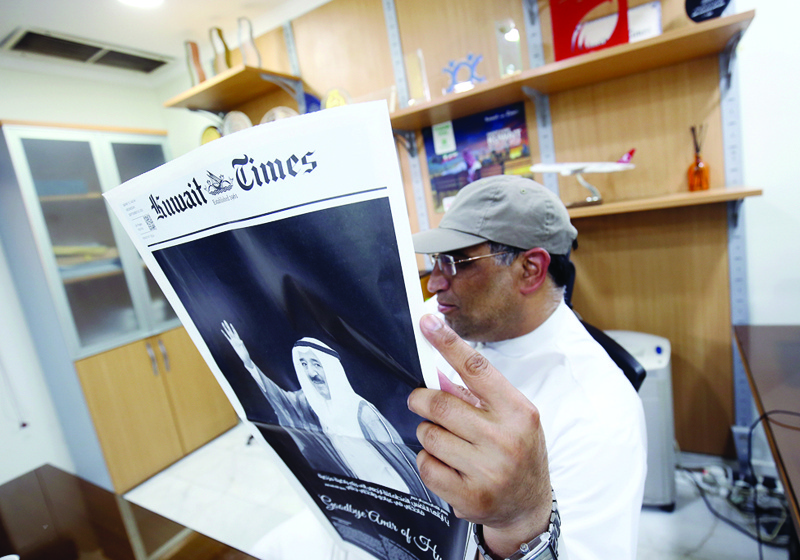 A Kuwaiti man reads a local daily newspaper in Kuwait City, on October 1, 2020. The news of the passing of Kuwait's Emir Sheikh Sabah Al-Ahmad Al-Ahmad Al-Sabah headlined news of local dailies issued in Kuwait since the late ruler's passing on Tuesday.