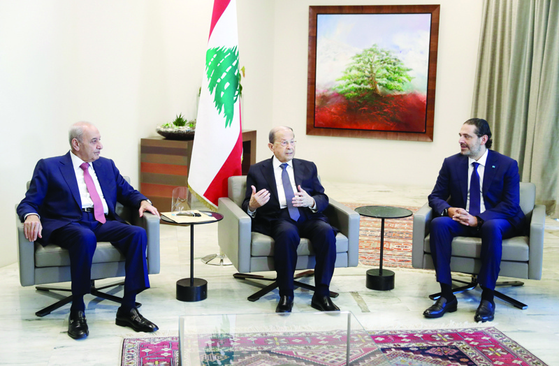 Lebanon's Parliament Speaker Nabih Berri (L) President Michel Aoun (C) and former prime minister Saad Hariri meet at the presidential palace in Baabda, east of the capital Beirut, after Aoun named Hariri to form a new cabinet, on October 22, 2020. - Aoun today named former premier Saad Hariri to form a new cabinet to lift the country out of crisis after most parliamentary blocs backed his nomination.nHariri, who has previously led three governments in Lebanon, stepped down almost a year ago under pressure from unprecedented protests against the political class. (Photo by ANWAR AMRO / POOL / AFP)