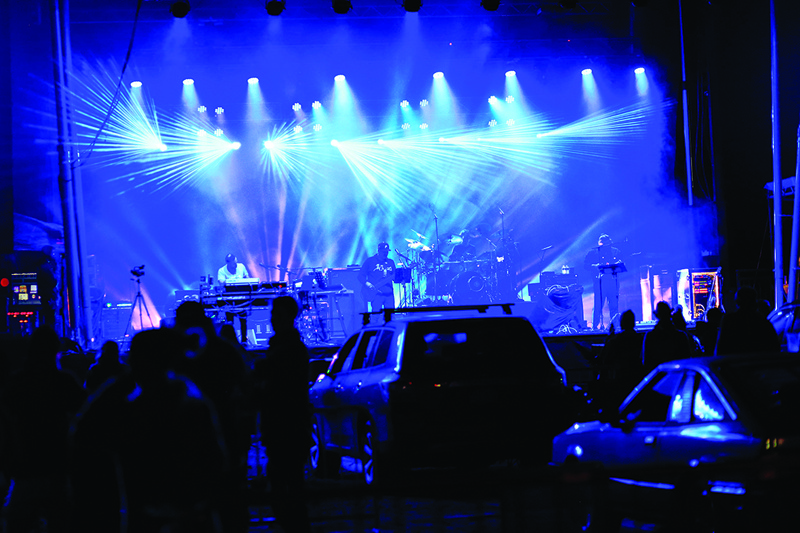 The Disco Biscuits band performs on stage during the Montage Mountain rave on October 23, 2020 in Scranton, Pennsylvania. - Clearly visible from afar with her flashing earrings and sequined jacket, Charity Valente is attending her first drive-in rave: a night of electronic music where the party-goers are in or around their cars, owing to the coronavirus pandemic. (Photo by Kena Betancur / AFP)