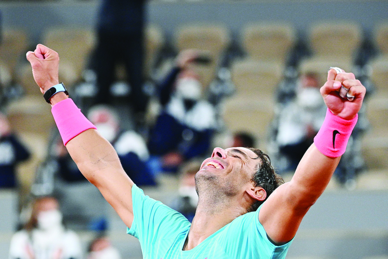 TOPSHOT - Spain's Rafael Nadal celebrates after winning against Serbia's Novak Djokovic at the end of their men's final tennis match at the Philippe Chatrier court on Day 15 of The Roland Garros 2020 French Open tennis tournament in Paris on October 11, 2020. (Photo by Anne-Christine POUJOULAT / AFP)
