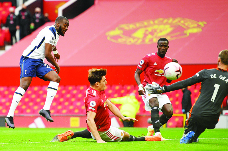 Tottenham Hotspur's French midfielder Tanguy Ndombele (L) shoots to score his team's first goal past Manchester United's Spanish goalkeeper David de Gea (R) to equalise during the English Premier League football match between Manchester United and Tottenham Hotspur at Old Trafford in Manchester, north west England, on October 4, 2020. (Photo by Oli SCARFF / AFP) / RESTRICTED TO EDITORIAL USE. No use with unauthorized audio, video, data, fixture lists, club/league logos or 'live' services. Online in-match use limited to 120 images. An additional 40 images may be used in extra time. No video emulation. Social media in-match use limited to 120 images. An additional 40 images may be used in extra time. No use in betting publications, games or single club/league/player publications. /