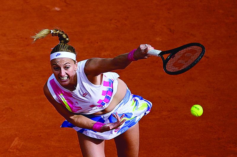 TOPSHOT - Czech Republic's Petra Kvitova serves the ball to Germany's Laura Siegemund during their women's singles quarter-final tennis match on Day 11 of The Roland Garros 2020 French Open tennis tournament in Paris on October 7, 2020. (Photo by MARTIN BUREAU / AFP)