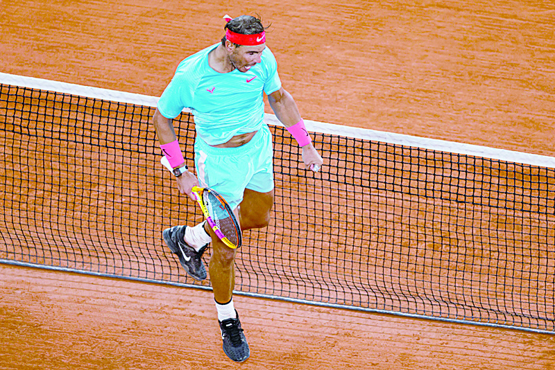 TOPSHOT - Spain's Rafael Nadal celebrates after winning against Slovakia's Norbert Gombos at the end of their men's singles third round tennis match at the Philippe Chatrier court on Day 6 of The Roland Garros 2020 French Open tennis tournament in Paris on October 2, 2020. (Photo by Thomas SAMSON / AFP)
