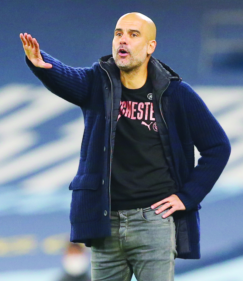 Manchester City's Spanish manager Pep Guardiola gestures during the English Premier League football match between Manchester City and Arsenal at the Etihad Stadium in Manchester, north west England, on October 17, 2020. (Photo by Alex Livesey / POOL / AFP) / RESTRICTED TO EDITORIAL USE. No use with unauthorized audio, video, data, fixture lists, club/league logos or 'live' services. Online in-match use limited to 120 images. An additional 40 images may be used in extra time. No video emulation. Social media in-match use limited to 120 images. An additional 40 images may be used in extra time. No use in betting publications, games or single club/league/player publications. /