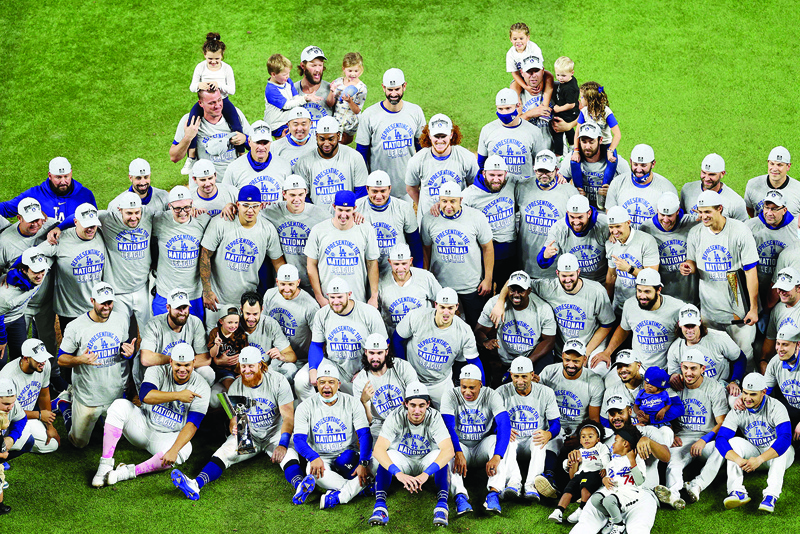 ARLINGTON, TEXAS - OCTOBER 18: The Los Angeles Dodgers pose for a photo following their 4-3 victory against the Atlanta Braves in Game Seven of the National League Championship Series at Globe Life Field on October 18, 2020 in Arlington, Texas.   Rob Carr/Getty Images/AFPn== FOR NEWSPAPERS, INTERNET, TELCOS &amp; TELEVISION USE ONLY ==