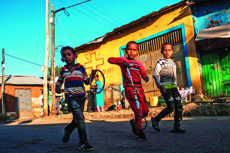 Children play in a street in Gondar, Ethiopia, on November 23, 2020. (Photo by EDUARDO SOTERAS / AFP)