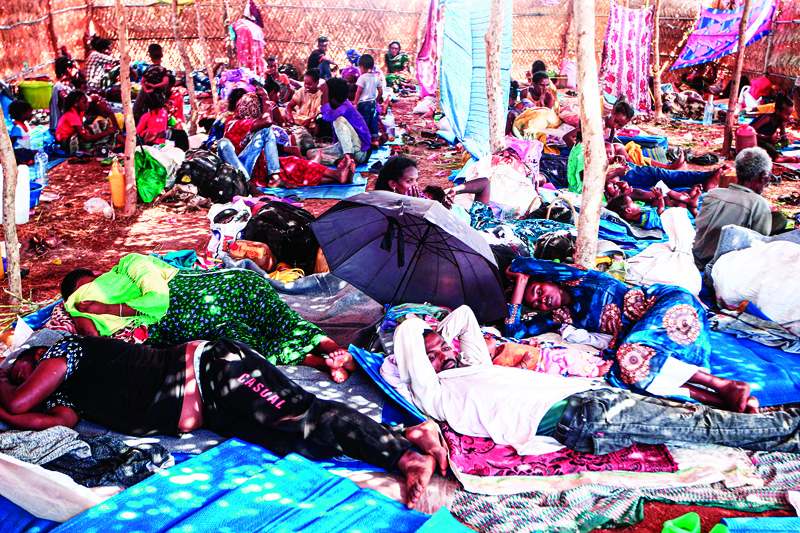 TOPSHOT - Ethiopian refugees who fled fighting in Tigray province lay in a hut at the Um Rakuba camp in Sudan's eastern Gedaref province, on November 16, 2020. - Sudan -- one of the world's poorest countries, now faced with the massive influx -- has reopened the camp, 80 kilometres (50 miles) from the border. It once housed refugees who fled Ethiopia's 1983-85 famine that killed over a million people. (Photo by Ebrahim HAMID / AFP)