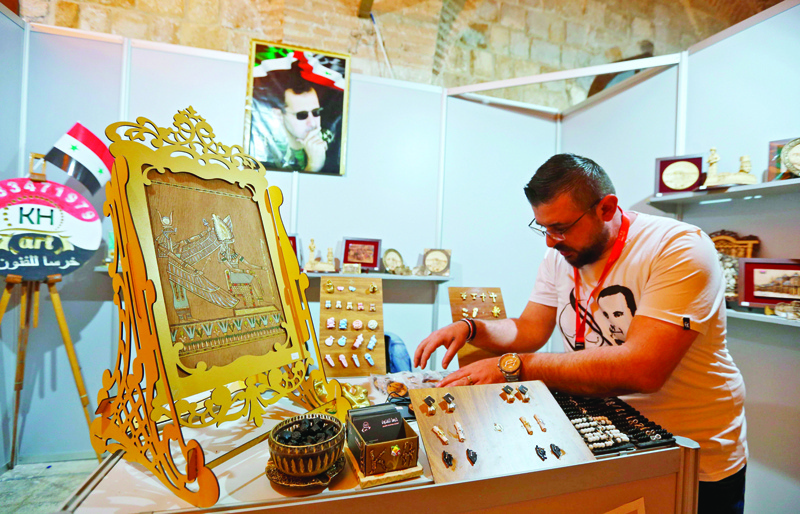 A jeweller from Aleppo displays his goods in a trade fair dedicated to war-hit businesses looking to make a revival, in the Syrian capital Damascus' Tekkiyeh Sulimaniyeh complex, on November 2, 2020. - Ghazal is among 137 merchants from the northern province of Aleppo taking part in the state-sponsored week-long fair for small-scale Aleppo businesses reeling from a nine-year conflict. nAleppo, a former economic hub, is renowned for its ancient artisanal crafts sold mostly in its Ottoman-era markets, hit hard by war. (Photo by LOUAI BESHARA / AFP)