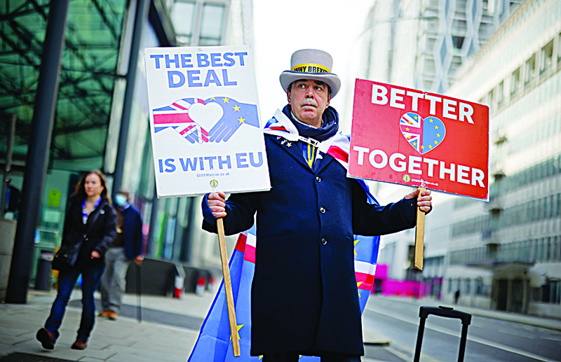Anti-Brexit campaigner Steve Bray holds placards outside a conference centre in central London on November 9, 2020 as talks on an UK-EU trade deal continue. - Britain and the European Union resumed crucial negotiations in London on Monday for a post-Brexit free trade deal, with time running short and both sides saying major obstacles remain. (Photo by Tolga Akmen / AFP)
