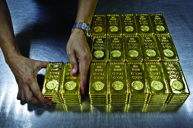 In this Tuesday Oct. 9, 2012 photo, technician prepares 1 Kg  gold bars of 995.0 purity to pack for delivery at the Emirates Gold company in Dubai, United Arab Emirates. Some traders predict prices could once again rise toward the record high of nearly $1,900 an ounce, as central governments and investors look to gold as a safe bet in the unsteady world economy. (AP Photo/Kamran Jebreili)