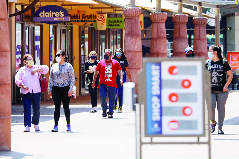 COMMERCE: Shoppers walk outside Citadel Outlet shopping mall in Commerce, California. — Reuters
