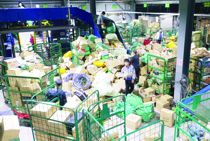 Workers sort packages for delivery at a warehouse of China Post Group in Hengyang, in central China's Hunan province on November 12, 2020, a day after the end of the Singles' Day shopping festival. (Photo by STR / AFP) / China OUT