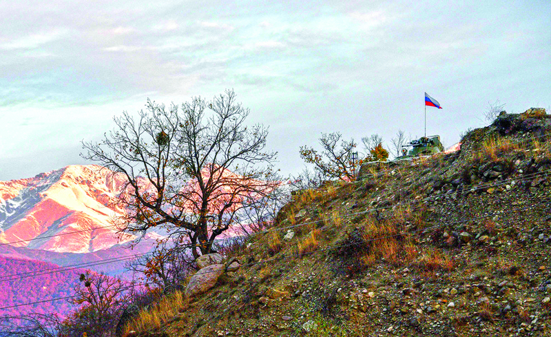 An Armoured Personnel carrier (APC) of Russian peacekeeping forces is stationed above the demarcation line near the village of Charektar on November 25, 2020, as Azerbaijan said its forces had entered the Kalbajar district, the second of three to be handed back by Armenia as part of a deal that ended weeks of fighting over Nagorno-Karabakh. (Photo by Karen MINASYAN / AFP)