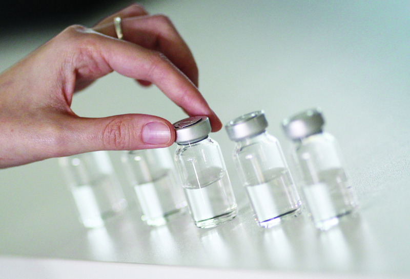 Pharmaceutical vials made by German glass company Schott are pictured at the company's headquarters in Mainz, western Germany, on November 20, 2020. - As expectations grow that the first Covid-19 jabs will be administered in a matter of weeks, German glassmaker Schott is quietly doing what it has been for months: churning out vials that will hold the vaccine. (Photo by Daniel ROLAND / AFP)