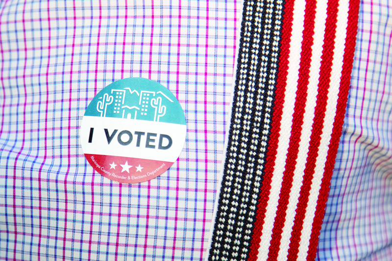 PHOENIX, AZ - NOVEMBER 03: An I voted sticker is placed on Eddie Slades shirt at Burton Barr Central Library on November 3, 2020 in Phoenix, Arizona. After a record-breaking early voting turnout, Americans head to the polls on the last day to cast their vote for incumbent U.S. President Donald Trump or Democratic nominee Joe Biden in the 2020 presidential election.   Courtney Pedroza/Getty Images/AFPn== FOR NEWSPAPERS, INTERNET, TELCOS &amp; TELEVISION USE ONLY ==