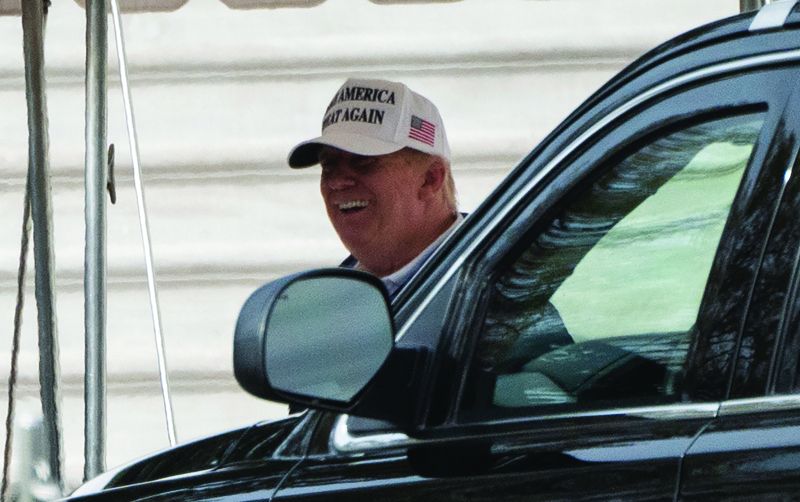 US President Donald Trump smiles as he gets into the motorcade as he departs the White House in Washington, DC on November 22, 2020. (Photo by ANDREW CABALLERO-REYNOLDS / AFP)