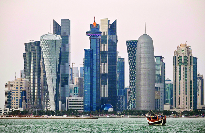 (FILES) This file photo taken on December 20, 2019, shows a view of boats moored in front of high-rise buildings in the Qatari capital, Doha. - Gas-rich Qatar has flung open its property market to foreigners, with a scheme giving those purchasing homes or stores the right to call the Gulf nation home. (Photo by GIUSEPPE CACACE / AFP)