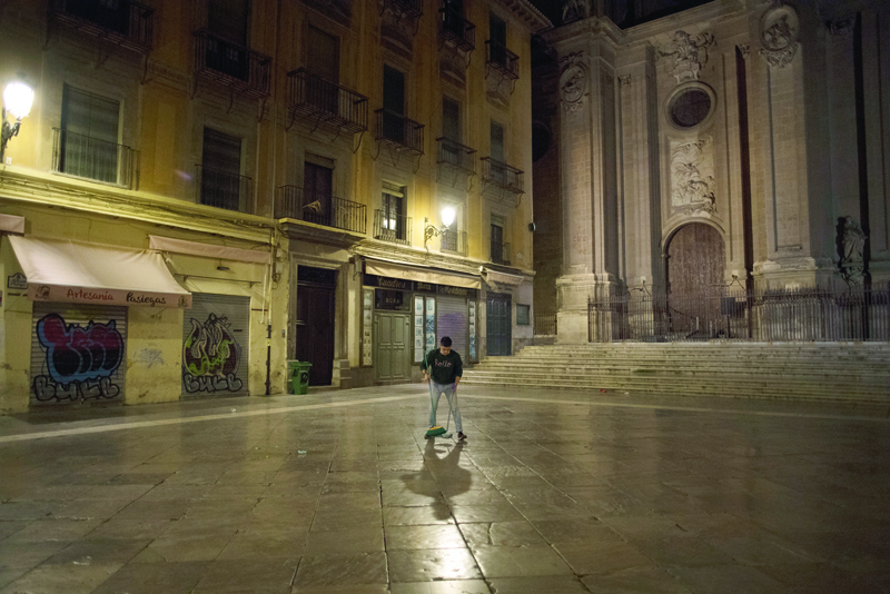 An employee sweeps after closing his business at Las Pasiegas Square at the end of a day's work in Granada on October 31, 2020. - The Spanish parliament on October 29 approved the extension for six months of a state of emergency declared to fight a surge in coronavirus infections. Under the state of emergency, Spain's 17 regional governments, which are in charge of health, can impose measures to restrict people's mobility, such as nighttime curfews and closing their borders. (Photo by JORGE GUERRERO / AFP)