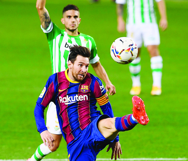 BARCELONA: Barcelona’s Argentine forward Lionel Messi kicks the ball during the Spanish League football match between Barcelona and Real Betis at the Camp Nou stadium yesterday. — AFP