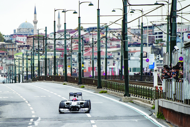 Scuderia AlphaTauri Honda French Formula One driver Pierre Gasly drive his car crosses the Galata Bridge during a Formula One promotional movie shooting in Istanbul, Turkey, on November 10, 2020. - The Formula One Grand Prix of Turkey will take place on 15 November 2020 at Intercity Istanbul Park. (Photo by Yasin AKGUL / AFP)