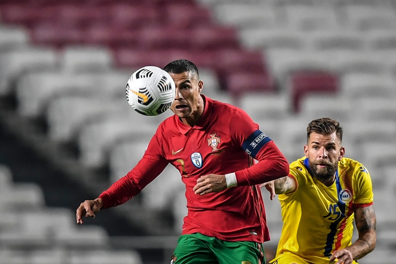Portugal's forward Cristiano Ronaldo (L) vies with Andorra's midfielder Moises San Nicolas during the international friendly football match between Portugal and Andorra at the Luz stadium in Lisbon on November 11, 2020. (Photo by PATRICIA DE MELO MOREIRA / AFP)