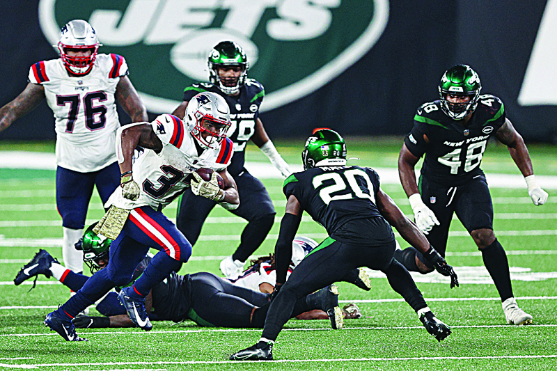 EAST RUTHERFORD, NEW JERSEY - NOVEMBER 09: Damien Harris #37 of the New England Patriots carries the ball as Marcus Maye #20 of the New York Jets defends during the second half at MetLife Stadium on November 09, 2020 in East Rutherford, New Jersey.   Elsa/Getty Images/AFP