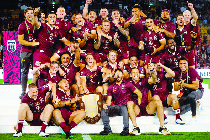 Queensland players celebrate following their victory in the State of Origin rugby league match between Queensland and New South Wales in Brisbane on November 18, 2020. (Photo by Patrick HAMILTON / AFP) / -- IMAGE RESTRICTED TO EDITORIAL USE - STRICTLY NO COMMERCIAL USE --