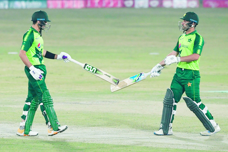 Pakistan's Haider Ali (L) celebrates hitting a boundary wiht teammate Khushdil Shahduring the second Twenty20 cricket match between Pakistan and Zimbabwe at the Rawalpindi Cricket Stadium in Rawalpindi on November 8, 2020. (Photo by Aamir QURESHI / AFP)