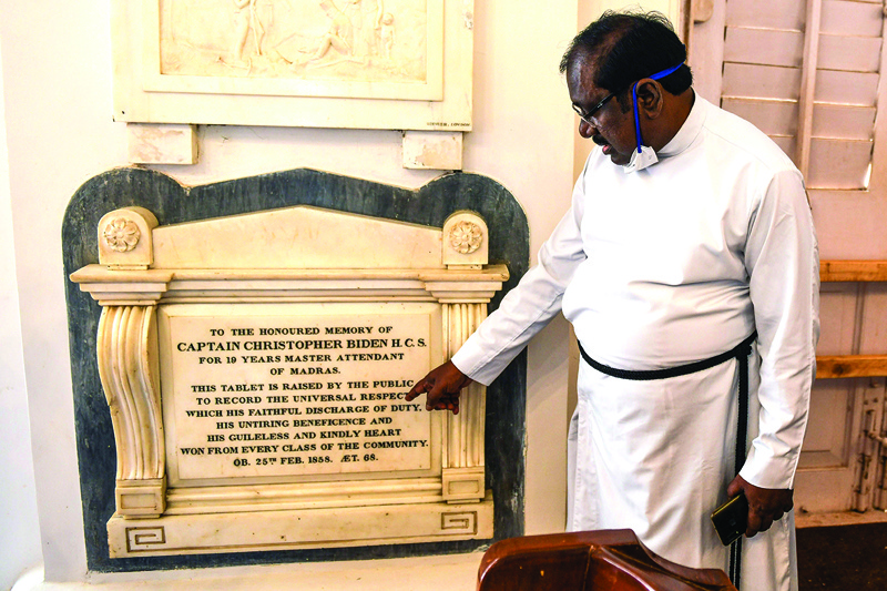 In this picture taken on November 10, 2020, a pastor shows a memorial tablet of Christoper Biden, a potential ancestor of US President-elect Joe Biden, at the St George's Cathedral in Chennai. - Already bursting with pride at Kamala Harris's Indian ancestry, the South Asian nation has started digging up potential local roots for US president-elect Joe Biden. (Photo by Arun SANKAR / AFP) / TO GO WITH 'US-vote-India-Biden' by Arun SANKAR and Vishal MANVE