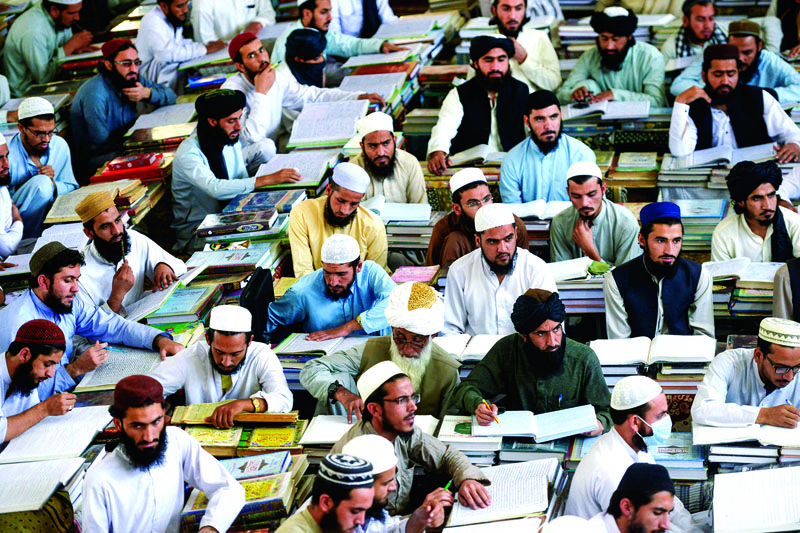 In this picture taken on October 19, 2020 Islamic seminary students attend class at the Darul Uloom Haqqania seminary in Akora Khattak. - The Darul Uloom Haqqania seminary has churned out a who's who of Taliban top brass -- including many now on the hardline group's negotiating team holding talks with the Kabul government to end a 20-year war. (Photo by Abdul MAJEED / AFP) / TO GO WITH 'Pakistan-Afghanistan-conflict-Islam - FOCUS' by David STOUT