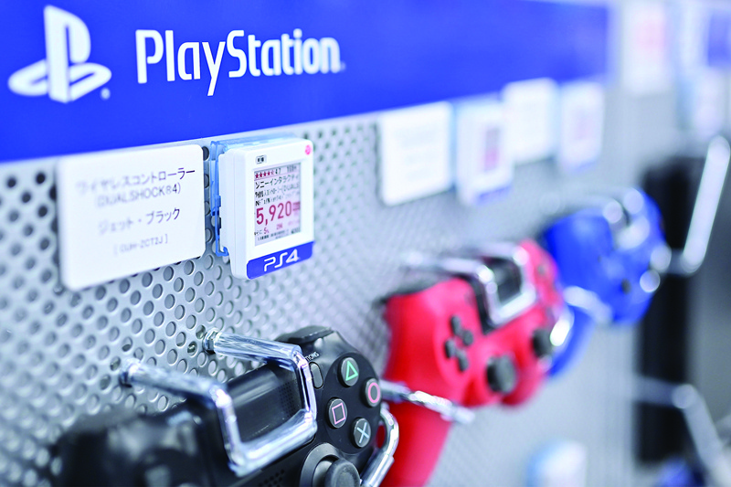 (FILES) This file photo taken on October 22, 2020 shows Sony Playstation 4 gaming controllers for sale at a store in Tokyo. - Sony launches its PlayStation 5 console on November 12, 2020 angling for a mega-hit, and with the Japanese firm increasingly dependent on the lucrative gaming sector there is little room for error. (Photo by CHARLY TRIBALLEAU / AFP) / TO GO WITH Games-consoles-IT-lifestyle-Asia-USA,FOCUS by Mathias CENA