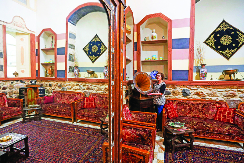 Nahida Mabardi takes care of her heritage house in the old part of Syria's capital Damascus on October 28, 2020. - The old city of the Syrian capital is famed for its elegant century-old houses, usually two storeys built around a leafy rectangular courtyard with a carved stone fountain at its centre. While the capital has been largely spared the violence of Syria's almost ten-year war, several of these traditional homes have been abandoned by their owners or damaged in the conflict. (Photo by LOUAI BESHARA / AFP)
