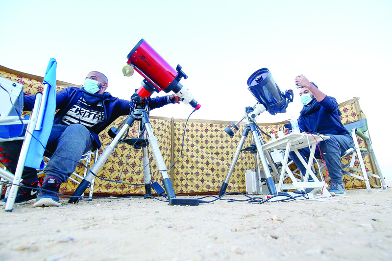 Kuwaiti astrophotographers Mohammad al-Obaidi (R) and Abdullah al-Harbi follow the great conjunction between Jupiter and Saturn in al-Salmi district, a desert area 120 kms west of Kuwait City, on December 21, 2020. - The great conjunction refers to the alignment of Jupiter and Saturn. (Photo by YASSER AL-ZAYYAT / AFP)