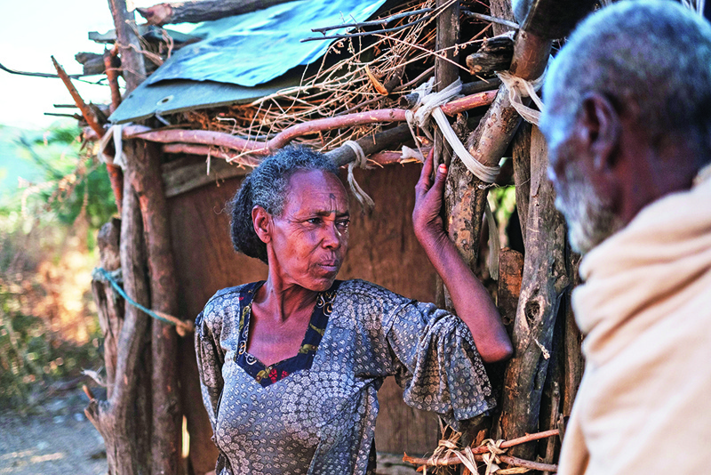 Jano Admasi, whose son was reportedly killed by the Ethiopian Defense Forces during the fightings that broke out in Ethiopia's Tigray region, poses with her husband at her house in the village of Bisober, on December 9, 2020. - Tigrayan forces settled in the school several months ago. The November 14 killings represent just one incident of civilian suffering in Bisober, a farming village home to roughly 2,000 people in southern Tigray. In retrospect, Bisober residents say, the first sign of the conflict came seven months ago, when members of the Tigray Special Forces took over the village elementary school, which had been emptied because of the coronavirus pandemic. (Photo by EDUARDO SOTERAS / AFP)