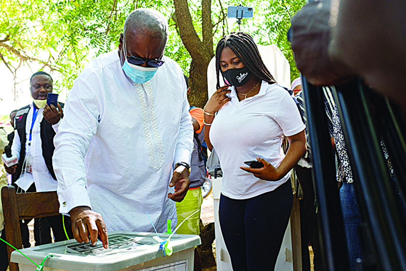 Former Ghana's President John Dramani Mahama casts his ballot as he votes for the presidential and parliamentary election at an open-air polling station, in his hometown Bole, Ghana, on December 7, 2020. - More than 17 million people are eligible to vote in presidential and parliamentary elections in Ghana with the race for the top job expected to be a close-run fight between incumbent Nana Akufo-Addo and longtime opponent John Mahama. (Photo by Nipah Dennis / AFP)