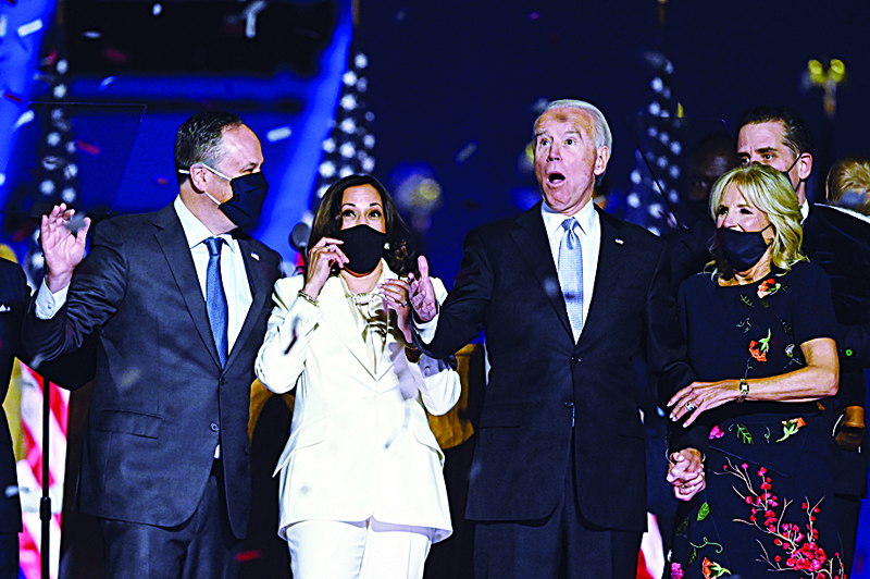 -- AFP PICTURES OF THE YEAR 2020 --nnUS President-elect Joe Biden (R) and Vice President-elect Kamala Harris (2nd L) react as confetti falls, with Jill Biden (R) and Douglas Emhoff, after delivering remarks in Wilmington, Delaware, on November 7, 2020, after being declared the winners of the presidential election. (Photo by Jim WATSON / AFP)