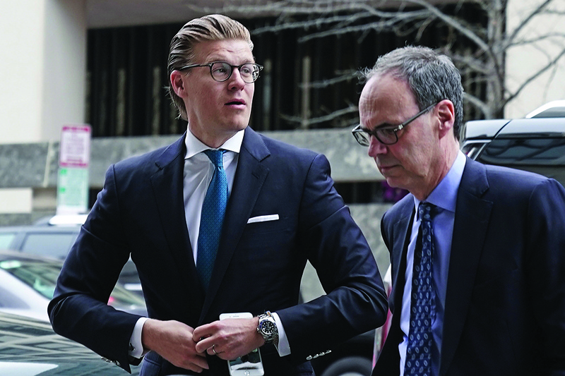 (FILES) In this file photo taken on April 3, 2018 attorney Alex van der Zwaan (L), who formerly worked for the Skadden Arps law firm, arrives at a US District Courthouse for his sentencing in Washington, DC. - US President Donald Trump granted pardons on December 22, 2020 to two people linked to a probe into alleged collusion between his campaign and Russia along with a list of others as time ticks away on his remaining weeks in office. A full pardon was granted to Alex van der Zwaan, a Dutch lawyer who was also convicted in connection with Mueller's probe. (Photo by ALEX WONG / GETTY IMAGES NORTH AMERICA / AFP)