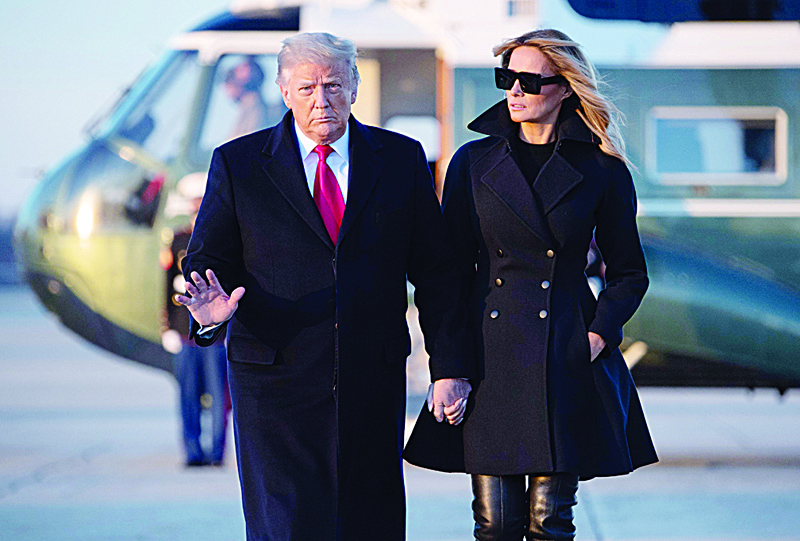 TOPSHOT - US President Donald Trump and First Lady Melania Trump walk to board Air Force One prior to departure from Joint Base Andrews in Maryland, December 23, 2020, as they travel to Mar-a-lago for Christmas and New Year's. (Photo by SAUL LOEB / AFP)
