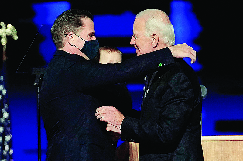 (FILES) In this file photo taken on November 07, 2020 US President-elect Joe Biden (R) embraces his son Hunter Biden (L) on stage after delivering remarks in Wilmington, Delaware. - US President-elect Joe Biden's son Hunter, a frequent target of Republican attacks during the 2020 election campaign, said December 9, 2020, he is under investigation for potential tax violations. (Photo by Andrew Harnik / POOL / AFP)