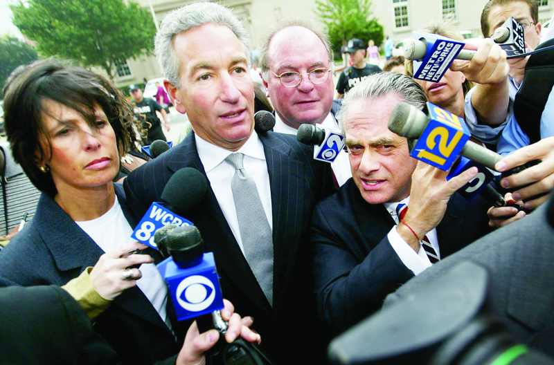 (FILES) In this file photo Charles Kushner (C) wades though the media with his wife and legal team to the U.S. District Courthouse on August 18, 2004 in Newark, NJ. - US President Donald Trump issued a new raft of pardons on December 23 for allies including Jared Kushner's father, adding to a long list he has granted in his waning days in office.nIn addition to the pardon for Charles Kushner -- the father of his son-in-law -- Trump also pardoned his 2016 campaign chairman Paul Manafort and longtime ally Roger Stone, the White House said in a statement. (Photo by Chris Hondros / GETTY IMAGES NORTH AMERICA / AFP)