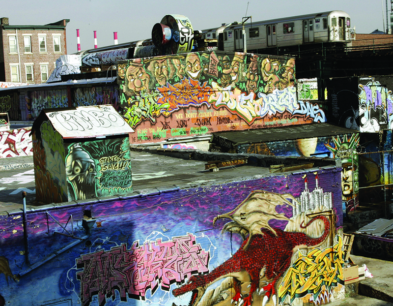 (FILES) In this file photo taken on February 22, 2006, the 7 Train passes by the 5 Pointz Building in Long Island City, Queens, New York. - They have been part of the city's history for more than 50 years, but with the pandemic, graffiti is flourishing as never before in New York, a sign of decadence for some, or vitality for others. (Photo by Timothy A. CLARY / AFP)