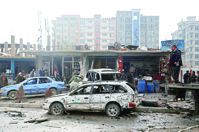 Damaged cars are seen at the site of an attack in Kabul on December 20, 2020. - A car bomb targeting an Afghan lawmaker killed nine people and wounded more than a dozen in Kabul on December 20, officials said, the latest attack to rock the capital. (Photo by Zakeria HASHIMI / AFP)