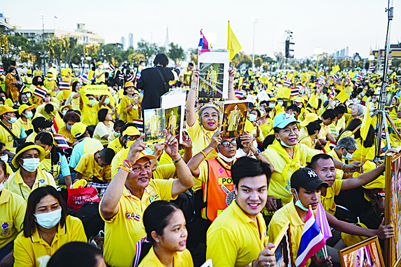 Royalists wait for the start of a ceremony to commemorate the birthday of the late Thai king Bhumibol Adulyadej at Sanam Luang in Bangkok on December 5, 2020. (Photo by Lillian SUWANRUMPHA / AFP)