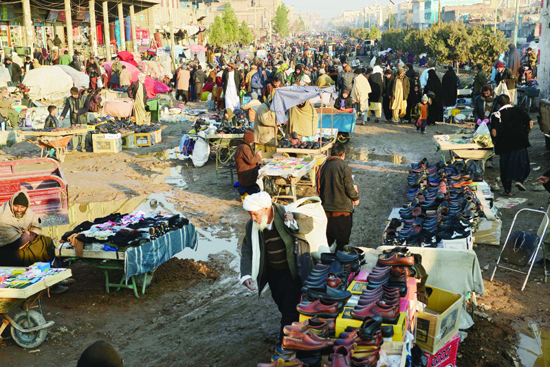 Shoppers crowd at a market in Herat on December 27, 2020. (Photo by Hoshang HASHIMI / AFP)