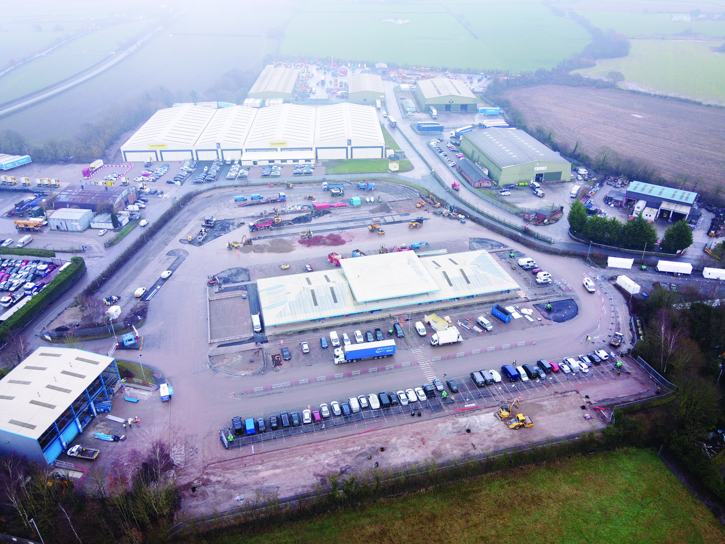 An aerial view shows the former Shearings coach holidays hub that is now being turned into a lorry park in Appleton Thorn near Warrington in north west England on December 7, 2020. - The site is at the junction of the M6 and the M56 on the route to the port of Holyhead in north Wales. The site is being adapted to handle overflow HGV traffic in advance of possible disruption at northern ports when the Brexit withdrawl period ends on January 1, 2021, according to reports. (Photo by Paul ELLIS / AFP)