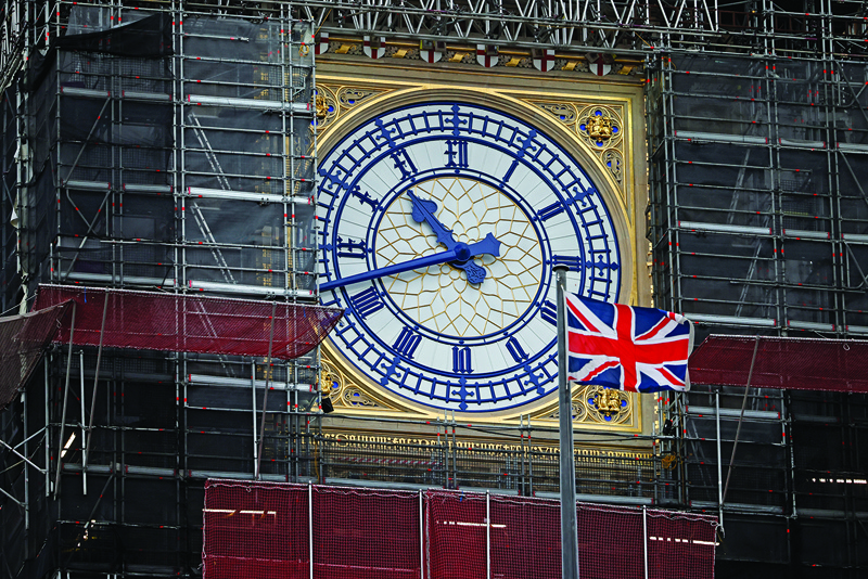 A Union flag flutters in the breeze in front of the clock face of the Elizabeth Tower, known after the bell Big Ben, in central London on December 13, 2020. - Sunday is just the latest in a string of supposedly hard deadlines for the negotiations but, with Britain due to leave the EU single market in 19 days, tensions are rising. (Photo by Tolga Akmen / AFP)